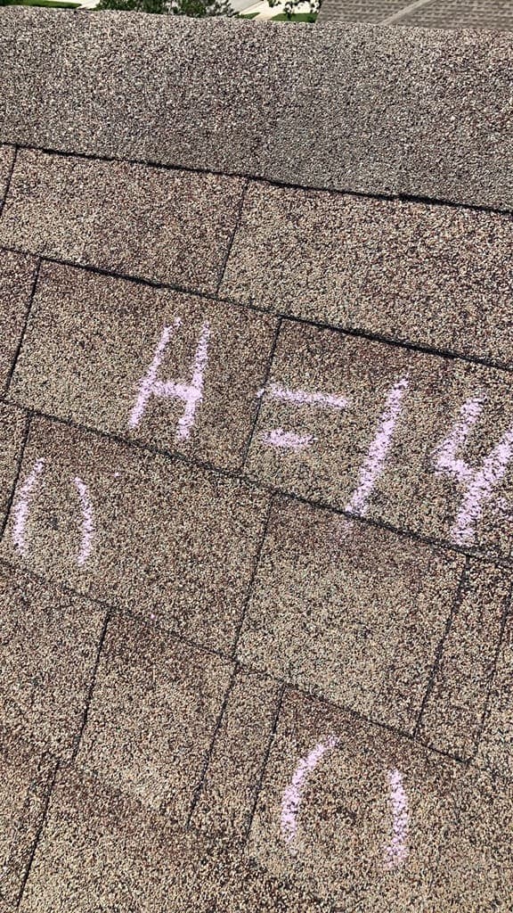 Asphalt shingles with chalk-circled hail hits and the notation H=14 marking fourteen hits in a test square
