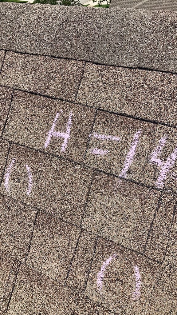 Asphalt shingles with chalk-circled hail hits and the notation H=14 marking fourteen hits in a test square